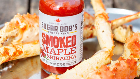 A bottle of Sugar Bob’s Maple Sriracha in the middle of some seafood