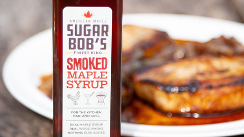 A bottle of Sugar Bob’s Smoked Maple Syrup with some food next to it