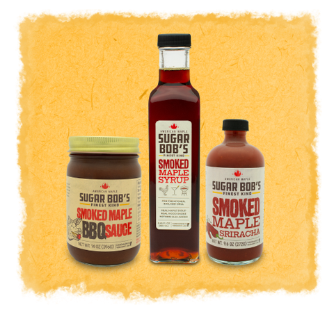 Three bottles of Sugar Bob's smoked maple products on a textured yellow background