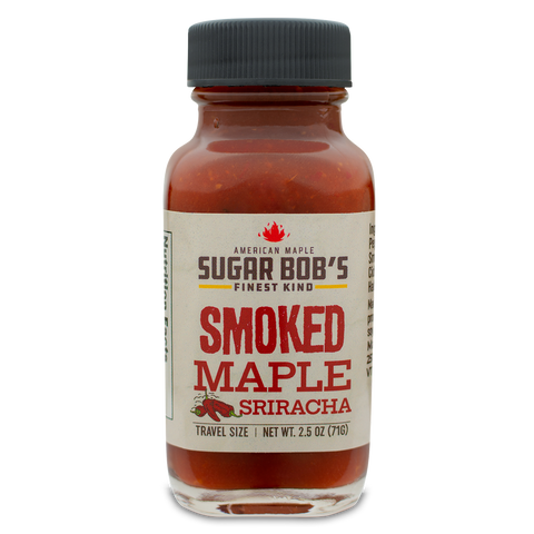 Bottle of smoked maple sriracha sauce with label on white background