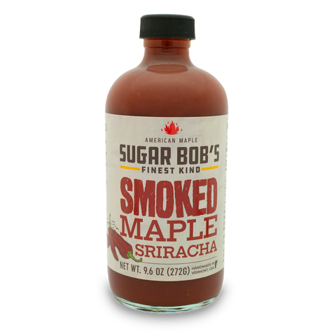 Bottle of Sugar Bob's Smoked Maple Sriracha hot sauce with a label showing the brand and product name.
