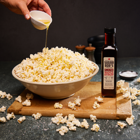 Smoked Maple Syrup bottle paired with a bowl of popcorn for a sweet and smoky snack during the movie