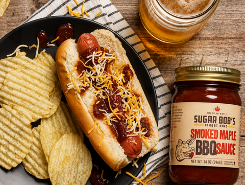 Sugar Bob's Smoked Maple BBQ Sauce and Vermont Maple Sriracha alongside grilled ribs and a summer spread — sweet and spicy Vermont maple hosting guide.