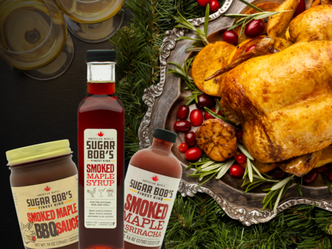 Gift set of Sugar Bob’s Smoked Maple Syrup, BBQ Sauce, and Vermont Maple Sriracha surrounded by gourmet holiday ingredients