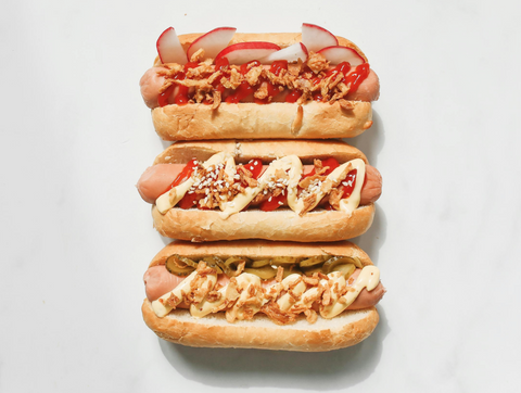 Grilled hot dog topped with Mexican street corn and Sugar Bob’s Jalapeño Maple Sriracha