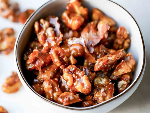 A bowl of smoked maple glazed walnuts