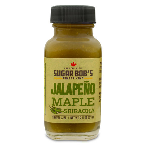 Bottle of jalapeño maple sriracha sauce with a label on a white background.