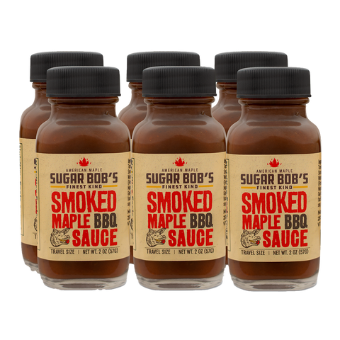 Six bottles of smoked maple BBQ sauce on a white background.