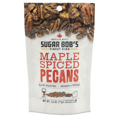 A package of Sugar Bob's Maple Spiced Pecans with visible roasted pecans in the background.