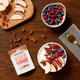 Yogurt bowl with fruits and almonds on a wooden table