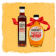 Two bottles of Sugar Bob's maple syrup with red ribbons on a textured yellow background