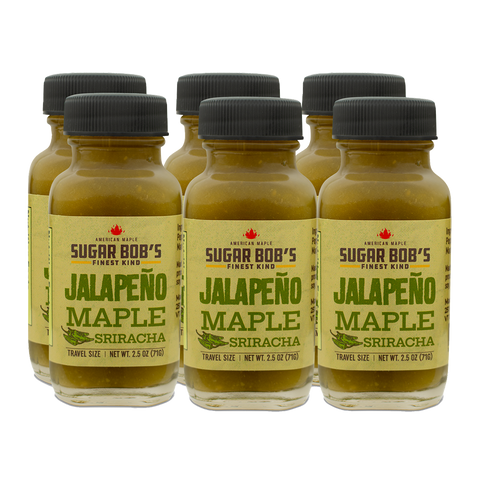 Six bottles of Jalapeño Maple Sriracha on a white background
