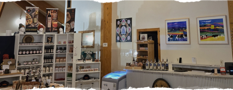 Panoramic view of a store interior with shelves, products, and wall art.