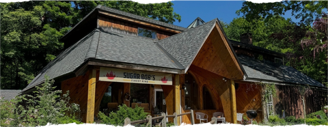 Sugar Bob's surrounded by trees and greenery.