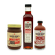Three bottles of Sugar Bob's smoked maple products on a white background