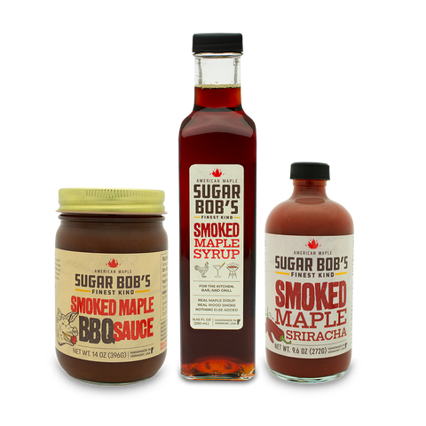 Three bottles of Sugar Bob's smoked maple products on a white background